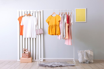 fashionable clothes on a rack in a bright interior of the wardrobe room