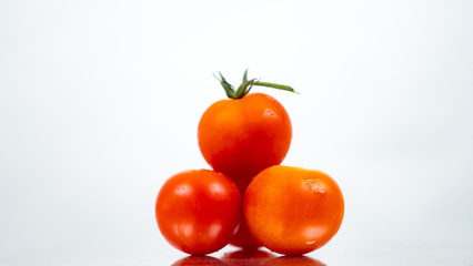 Red tomatoes on white background