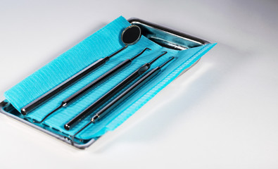 Dentist's tools.Sterile metal instruments are placed on clean blue and yellow napkins, and next to them-protective glasses.