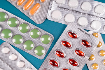 Colorful tablets and capsule pills in blister pack. Pharmaceutical industry. Pharmaceutical manufacturing concept.