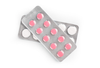 Pills of different colours lay on table. Colorful antibacterials pills, capsules of medicine. Pharmaceuticals antibiotics pills medicine. Blister packs antibiotics and pills top view.