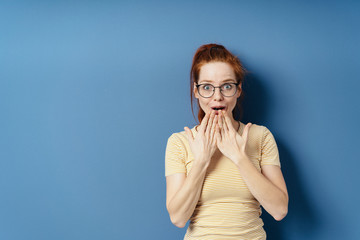 Young woman reacting in awe and astonishment