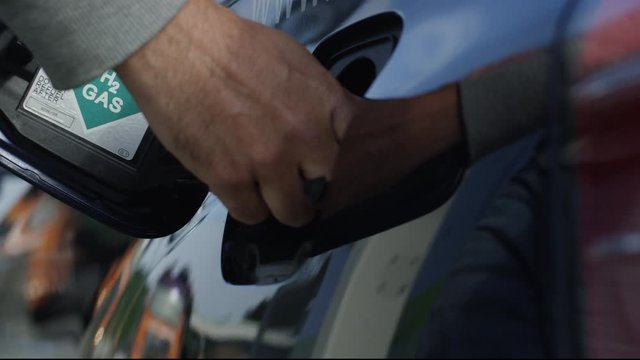Hydrogen car is being refueled at hydrogen gas station