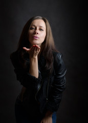 Portrait of beautiful sensual woman - she makes a air kiss.