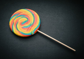 Natural looking lollipop on dark background.