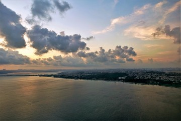 Amazing panorama of the Bosphorus and Istanbul from a height. Dawn. In the sky, clouds, painted in blue, pink, golden hues. Reflection in the calm water of the strait. Many city houses in the distance