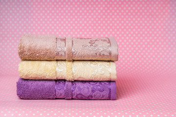 set of velvet towels on a pink background