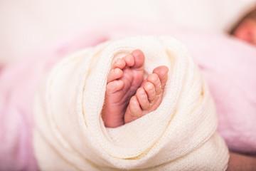 Newborn baby feet on soft blanket. Close up of newborn baby feet. Template for baby book or baby photo album.