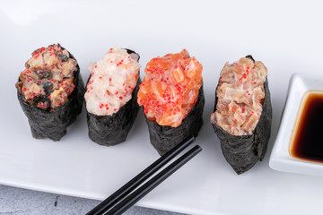 Traditional fresh japanese sushi on black stone Gunkan ebi on a black background.