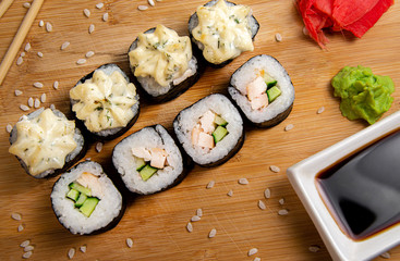 Rice rolls with smoked chicken and garlic sauce. Wood background. Photo for the menu