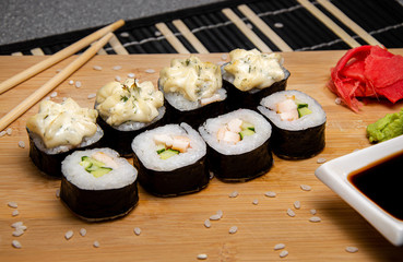 Rice rolls with smoked chicken and garlic sauce. Wood background. Photo for the menu