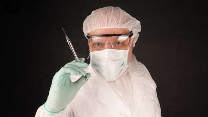 Doctor with protective masks medicine against epidemic pandemic virus disease as equipment protective suit prevention holding vaccine mandatory vaccination