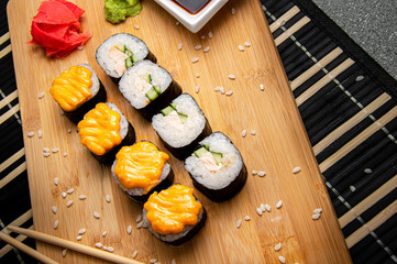 Rice rolls with smoked chicken and vegetables. Wood background. Photo for the menu