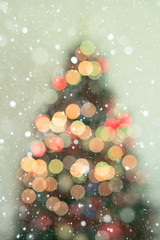 Blur lighting celebration on christmas tree with snowfall