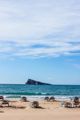 Obraz premium empty deck chairs by the sea, background with sea waves, sand and blue sky