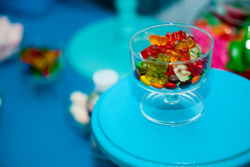 jelly candies and marshmallows on a blue background