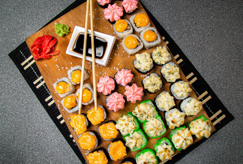 Set of baked roll. Cup with soy sauce. Chinese sticks. Photo for the menu.