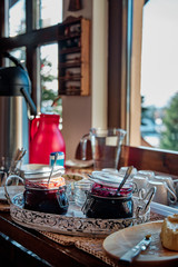 A breakfast buffet with homemade jams and butter at mountain cabin.