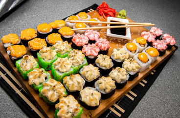 Set of baked roll. Cup with soy sauce. Chinese sticks. Photo for the menu.