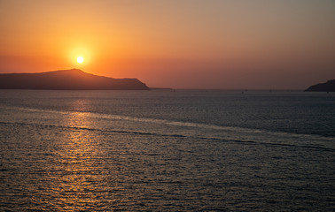 Naklejka na ściany i meble Santorini sunset from Fira, capital of the Greek Aegean island, Greece