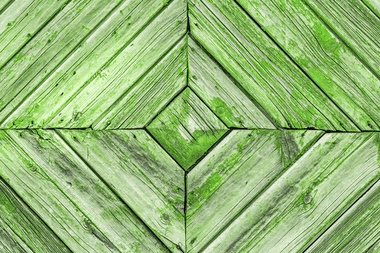 Vintage background green color from wooden batten. Old wood slats paint cracks.