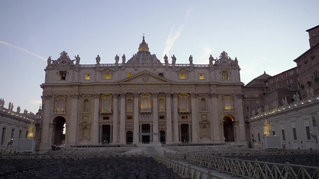 Slow motion shot of a bird flying over empty chairs in front of Saint Peters Basilica at Saint Peters square, Vatican City, Rome, Italy.