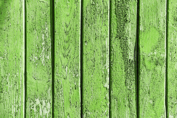 Vintage background green color from wooden batten. Old wood slats paint cracks.