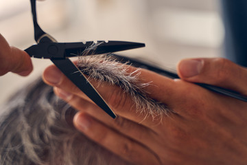 Photo of cutting hair with help of scissors