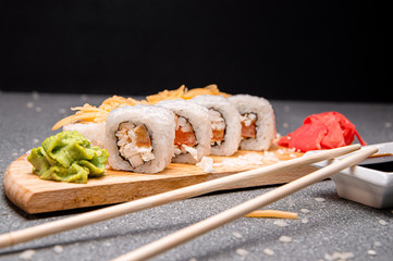 White rolls with grated cheese and chicken. Wooden stand. Photo for the menu