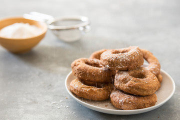 Homemade donuts sugar glazed on a stone background