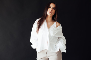 Portrait of a beautiful oriental fashionable brunette woman in shorts and white shirt