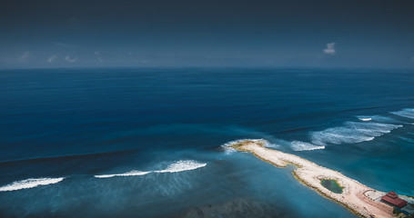 Fototapeta na wymiar Aerial Top View Photo Background from Flying Drone Above Beautiful Clear Sea Water. Wonderful Panoramic Blue Ocean Waves Background with a Tropical Aerial View for the Luxury Holidays