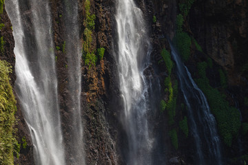 Close-up of the fresh and intense falling water in Tumpak Sewu Waterfall, in East Java, Indonesia.