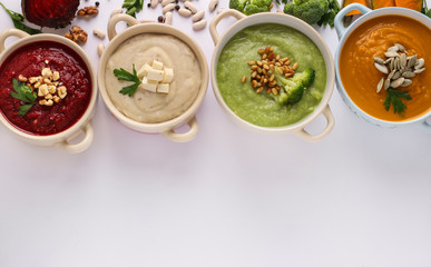 Variety of vegetables cream soups with broccoli, white beans, beet and pumpkin, ingredients for soup, Healthy eating concept, Top view, Space for text
