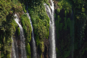 Close-up of the fresh and intense falling water in Tumpak Sewu Waterfall, in East Java, Indonesia.