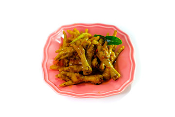 Asian food spicy chicken feet, served with a green plate isolated from a white background