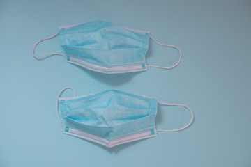 Surgical mask isolated against blue background shot from above