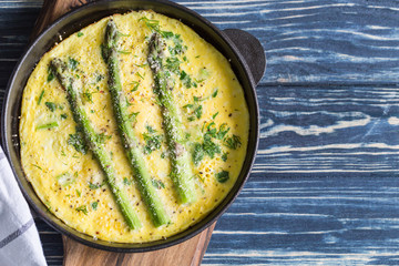 Asparagus with scrambled eggs. Omelet with asparagus  in a frying pan.