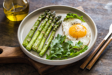 Healthy homemade breakfast with asparagus, fried egg and arugula. quarantine healthy eating...