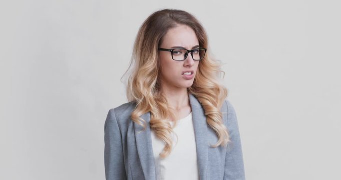 Discontent business woman covering nose with hand