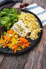 cod fish with vegetables, small vegetables and marine sauce
