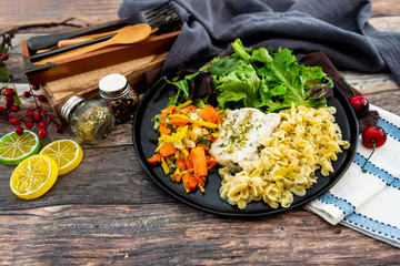 cod fish with vegetables, small vegetables and marine sauce