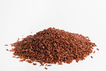 A pile of brown rice on a white background

