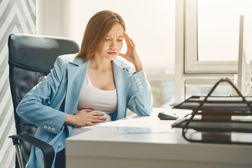 Beautiful pregnant woman feeling stressed at work