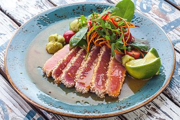 Sesame-roasted tuna with bell pepper, cherry tomatoes, chicken
egg, mix Italian leaves, ginger-lime dressing, soy sauce with citrus
and sesame oil