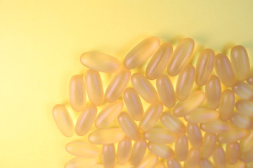 Omega 3 pills on the yellow background. Copy space. Place for text and design. Healthe care concept.