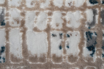 Spotted a fluffy background. The background is plush with white beige and blue spots. Shaggy background.