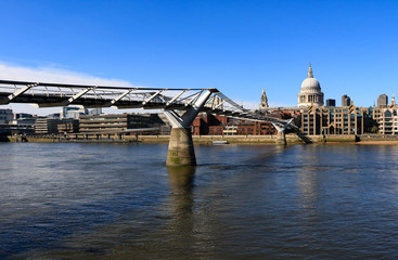 A view of the empty Millennium Bridge, St Paul's Cathedral and north side of the river Thames during Coronavirus lockdown in London, United Kingdom.