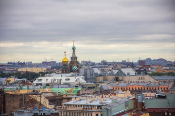 Fototapeta na wymiar View from the Colonnade of the Saint Isaac's Cathedral in St. Petersburg, Russia, roofs and the Savior on blood and the doms of the Savior on blood cathedral