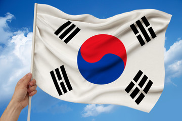 photo of the beautiful colored national flag of the modern state of South Korea on textured fabric, concept of tourism, emigration, economics and politics, closeup